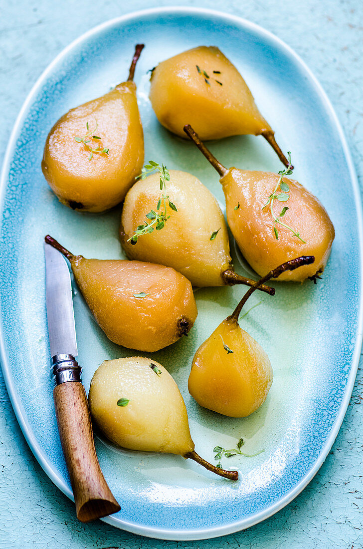 Poached pears on a blue plate