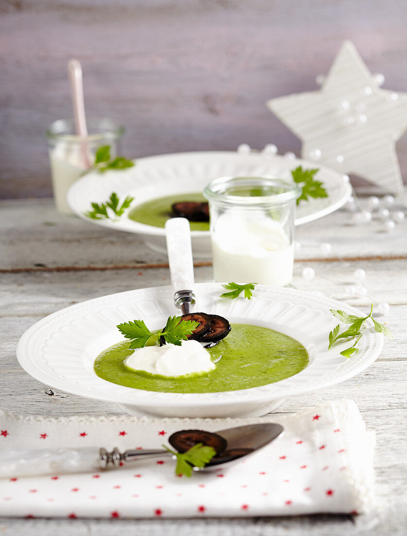 Pea and parsley soup with candied walnuts and crème fraîche