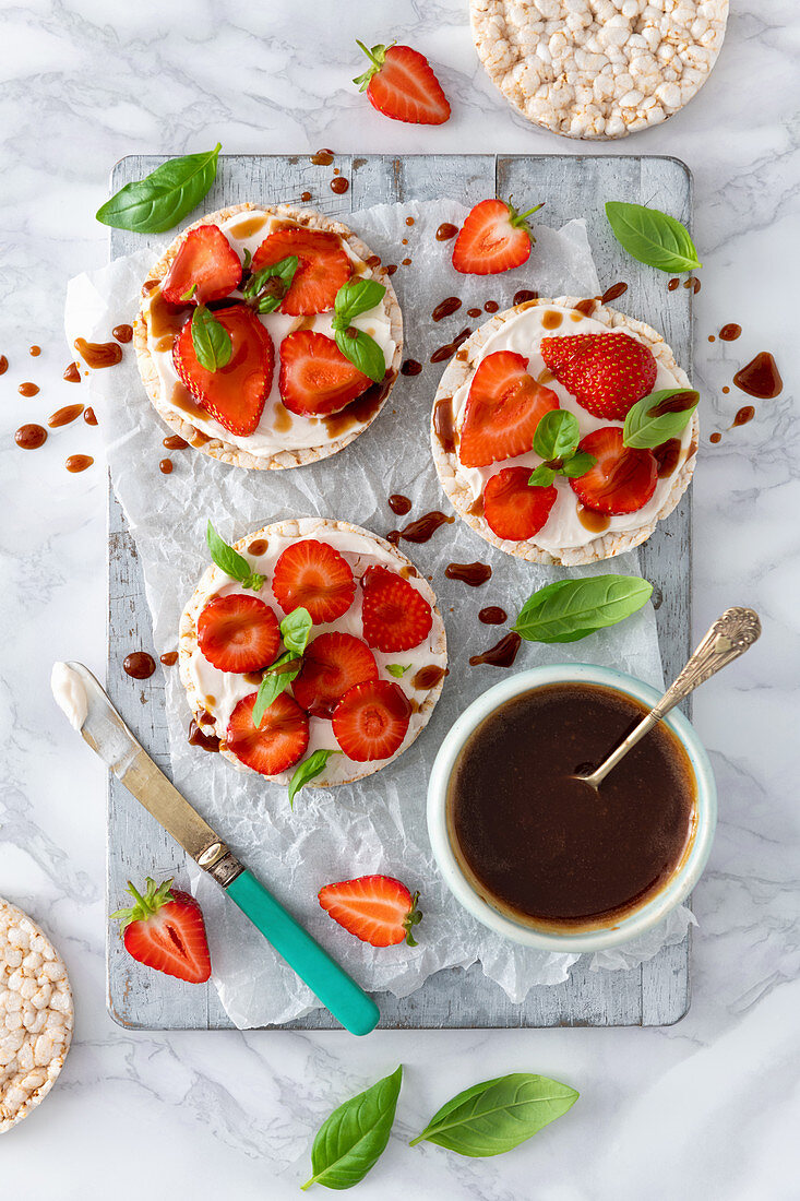 Vegan cream cheese strawberry basil and balsamic glaze on a rice cracker