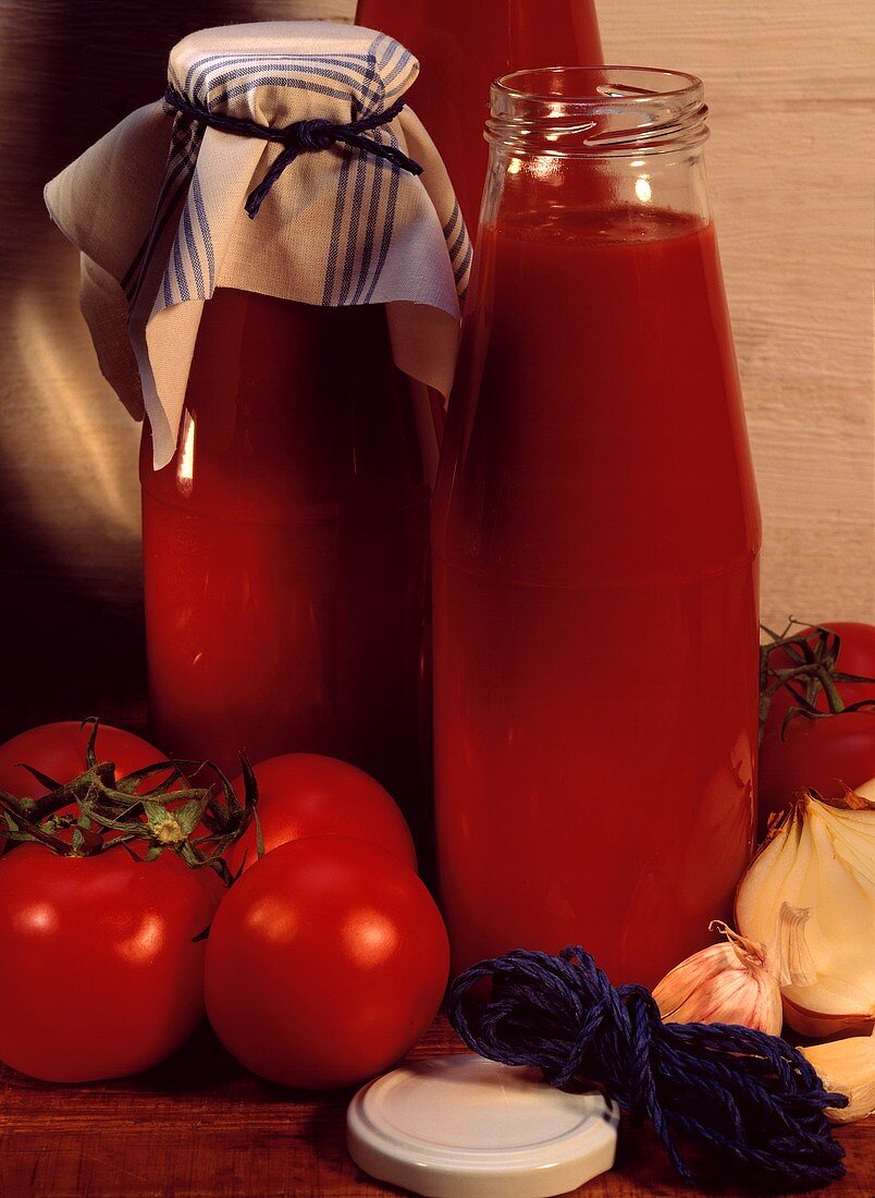 Bottles of Homemade Tomato Sauce; Tomatoes
