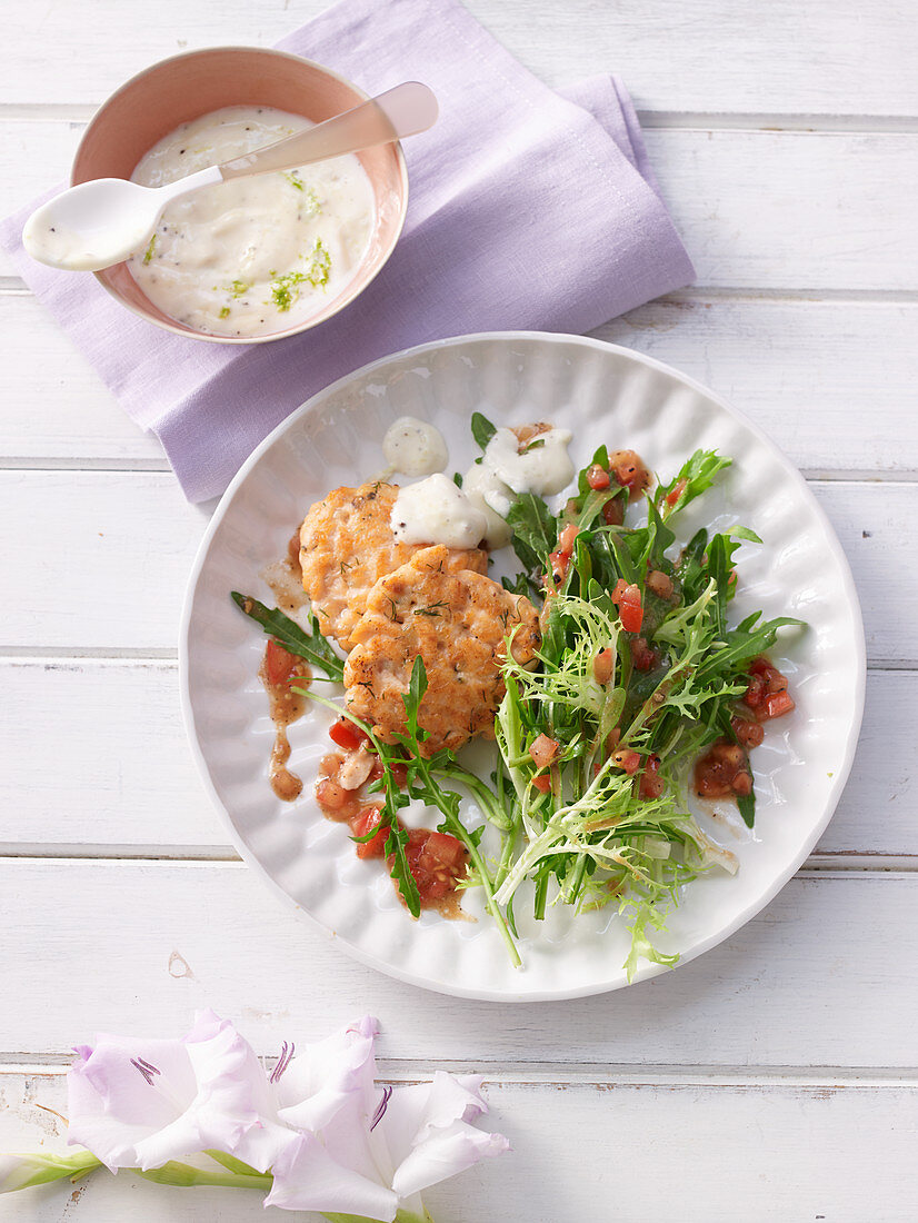 Salmon cakes with lime mayonnaise and salad