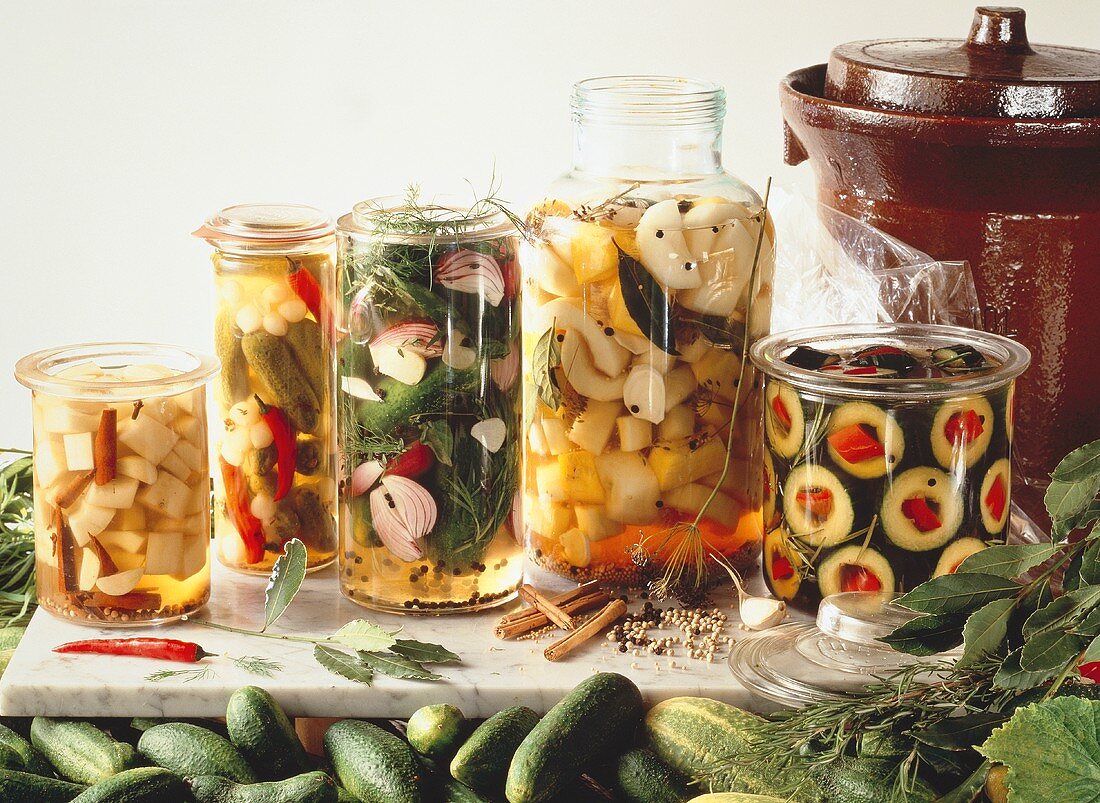 Various pickled gherkins in pickling jars