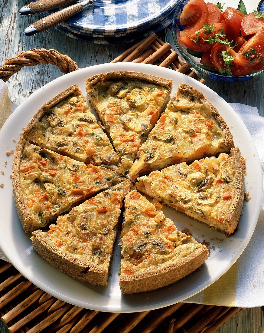 Quiche with button mushrooms & diced tomatoes, cut into pieces