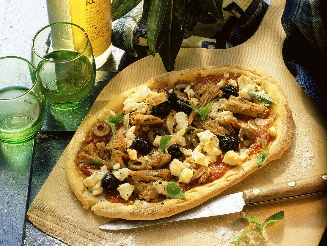 Pizza with Greek topping: sheep's cheese, olives and tuna