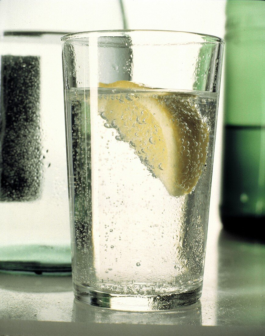 Mineral Water in a Glass with a Wedge of Lemon