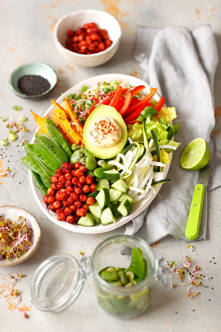 Vegan Buddha bowl with hummus, avo, sweet potatoes, baked chickpeas and vegetables