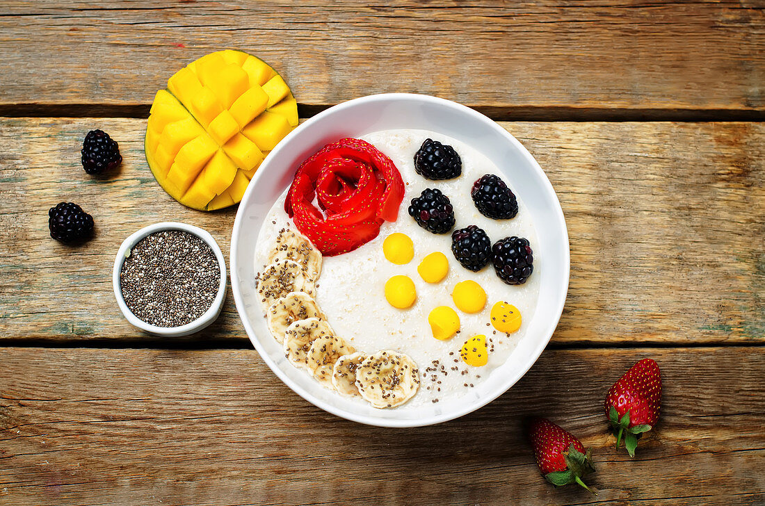 Breakfast oatmeal porridge with strawberry, mango, blackberry, banana and Chia seeds