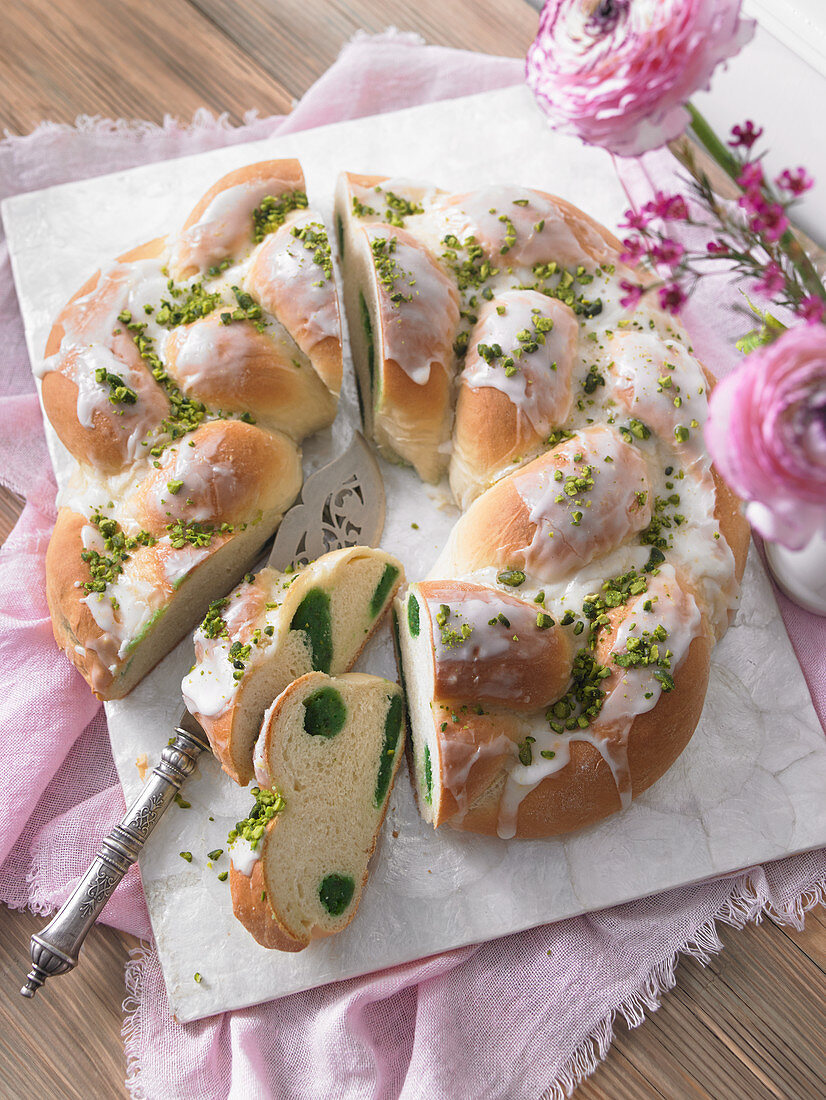 A pistachio yeast wreath with icing for Easter