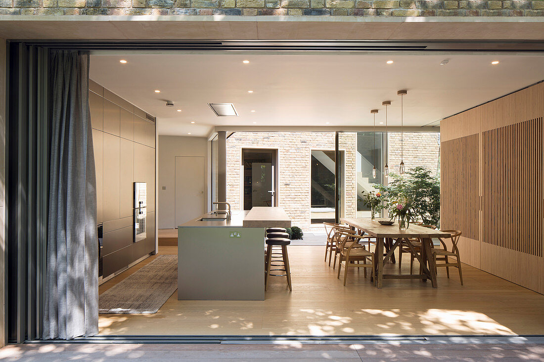 View into open-plan kitchen with dining area from terrace