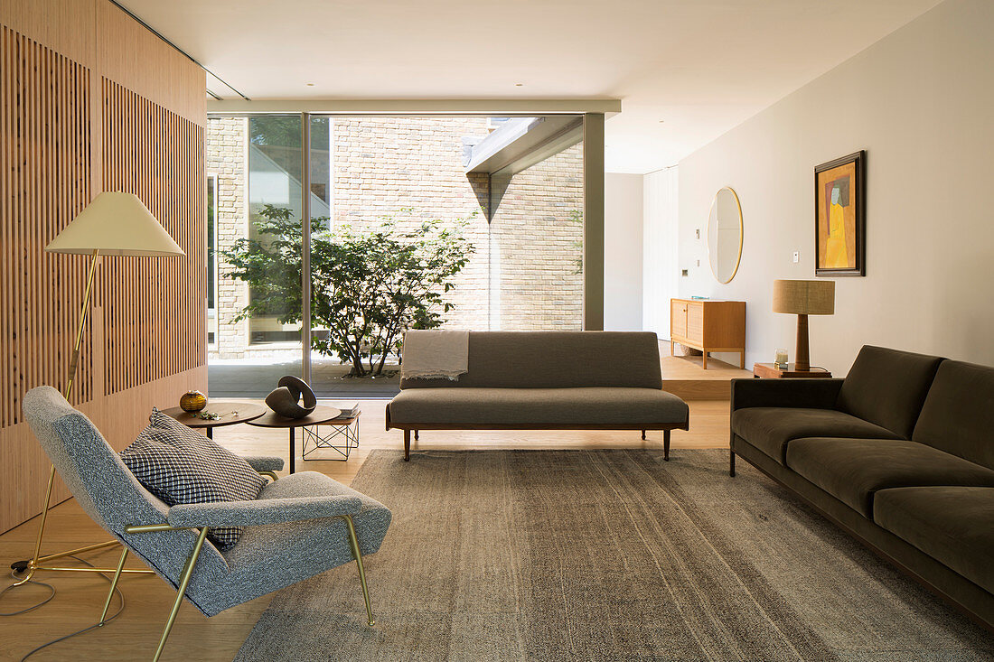 Lounge with view of courtyard through glass wall