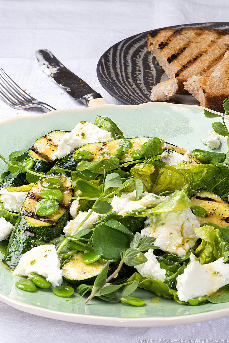 A salad with grilled zucchini, beans, oregano, goat's cheese and grilled bread