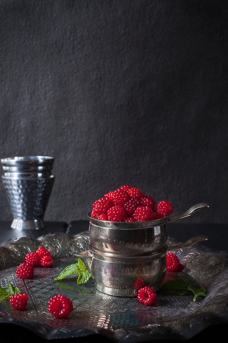 Fresh Wild Raspberried Piled in a Tarnished Silver Cup