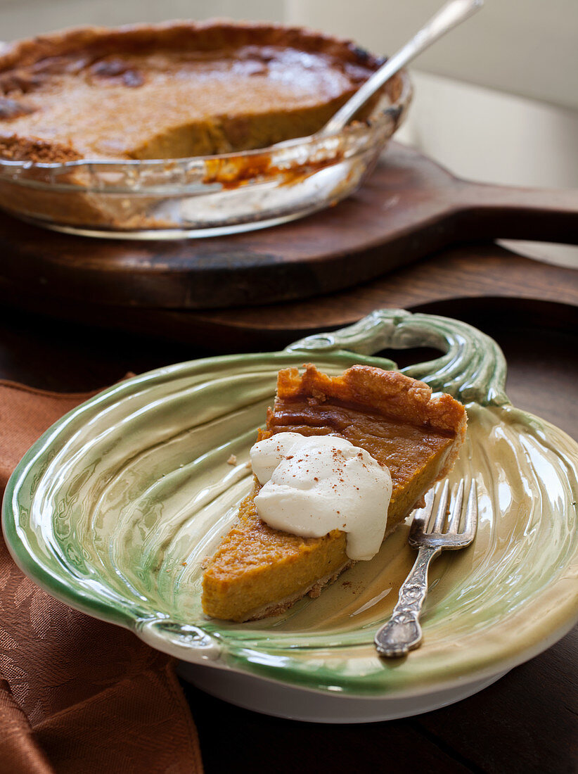 Slice of Sweet Potato Pie with Cream and Cinamon