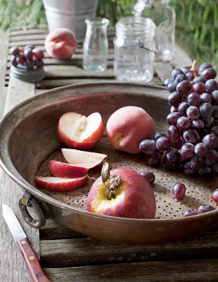 Metal Sieve with Grapes, Apple, and Sliced Peaches