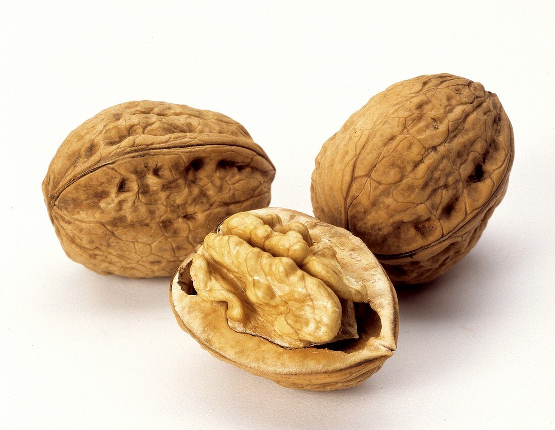 Three Walnuts; Two Whole and One Halved