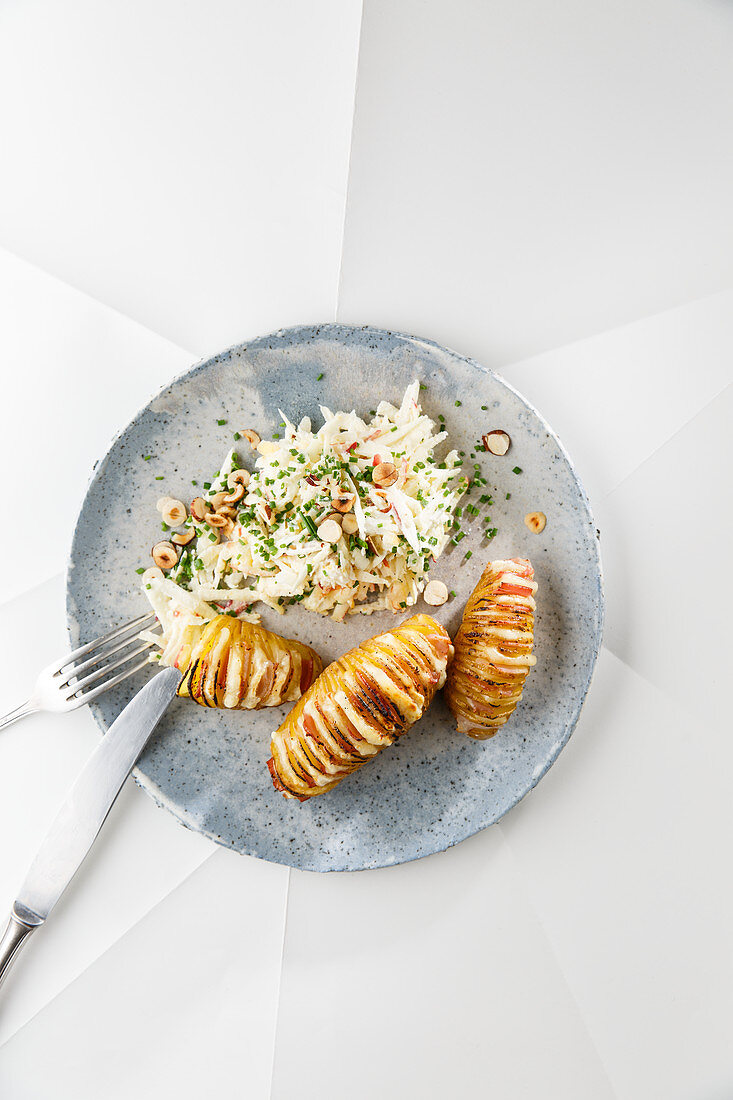 Hasselback potatoes with parsnip and raw apple salad