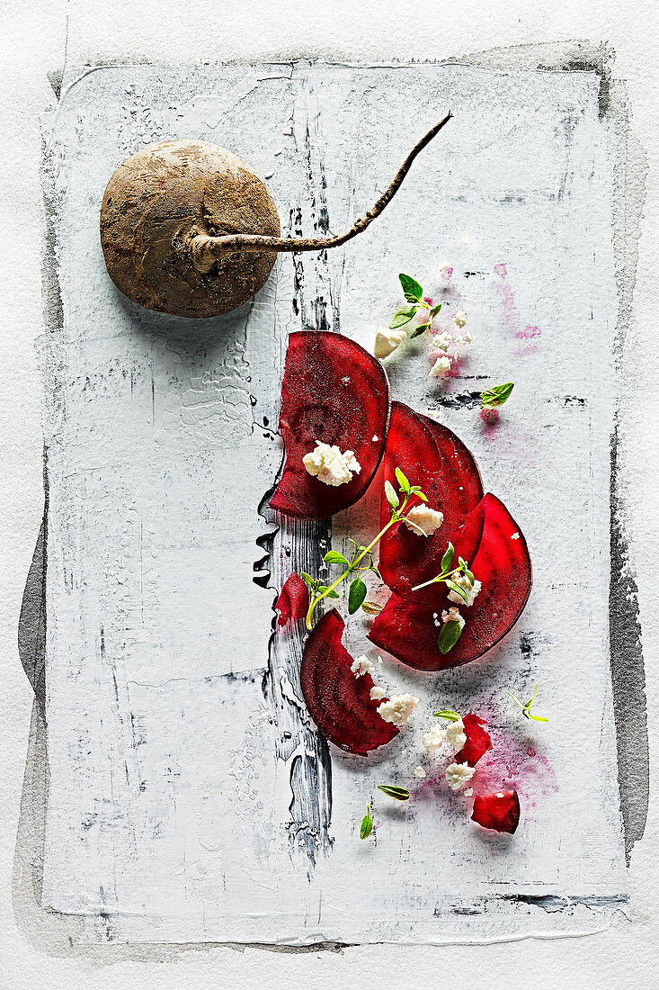 Food art: beetroot carpaccio with feta cheese and thyme