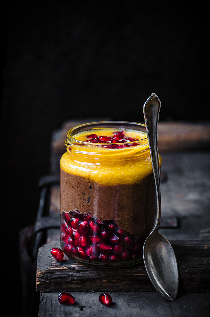 Blended chocolate chia pudding with orange and pomegranate