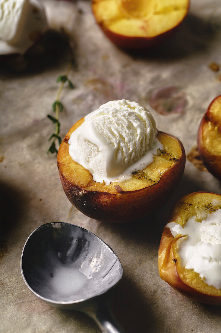 Melting vanilla ice cream served in hot grilled halved peaches and nectarines