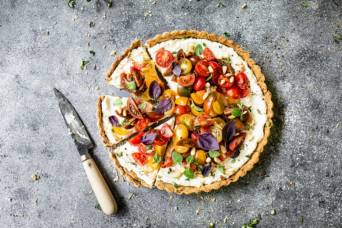 Tart with Heirloom Tomato and Ricotta on a gray background