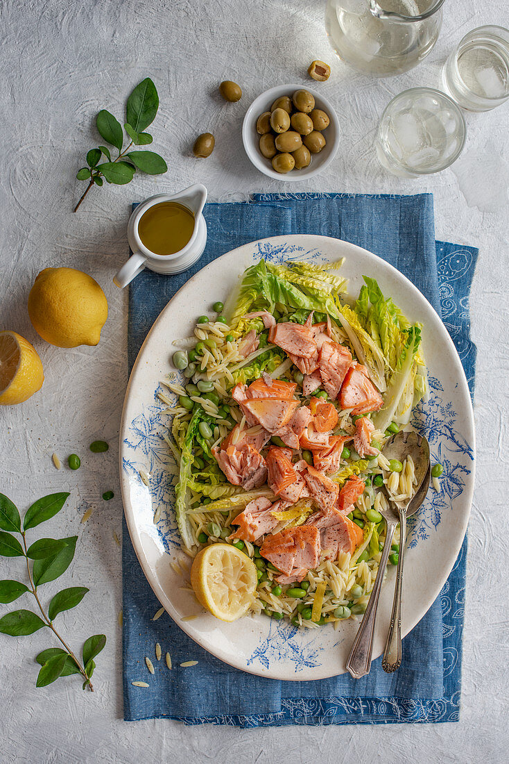 Orzo and hot smoked salmon salad with beans, letuce and lemon and olive oil dressing