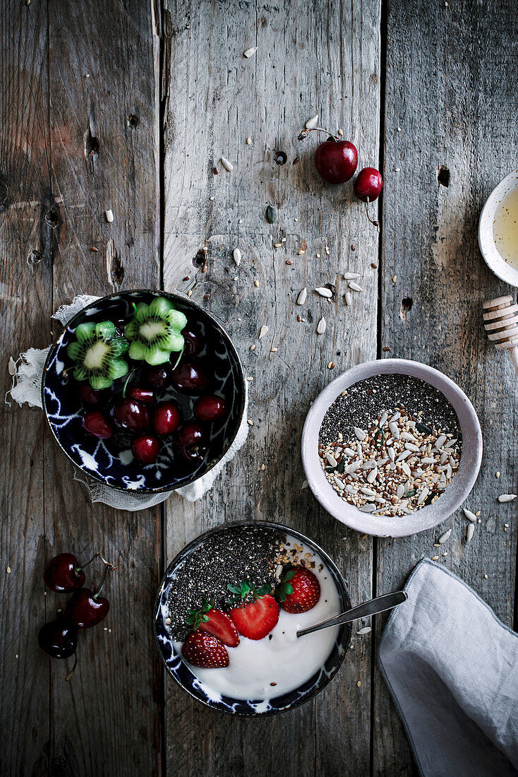 Healthy yoghurt, chia and fruit for breakfast, on a rustic kitchen table