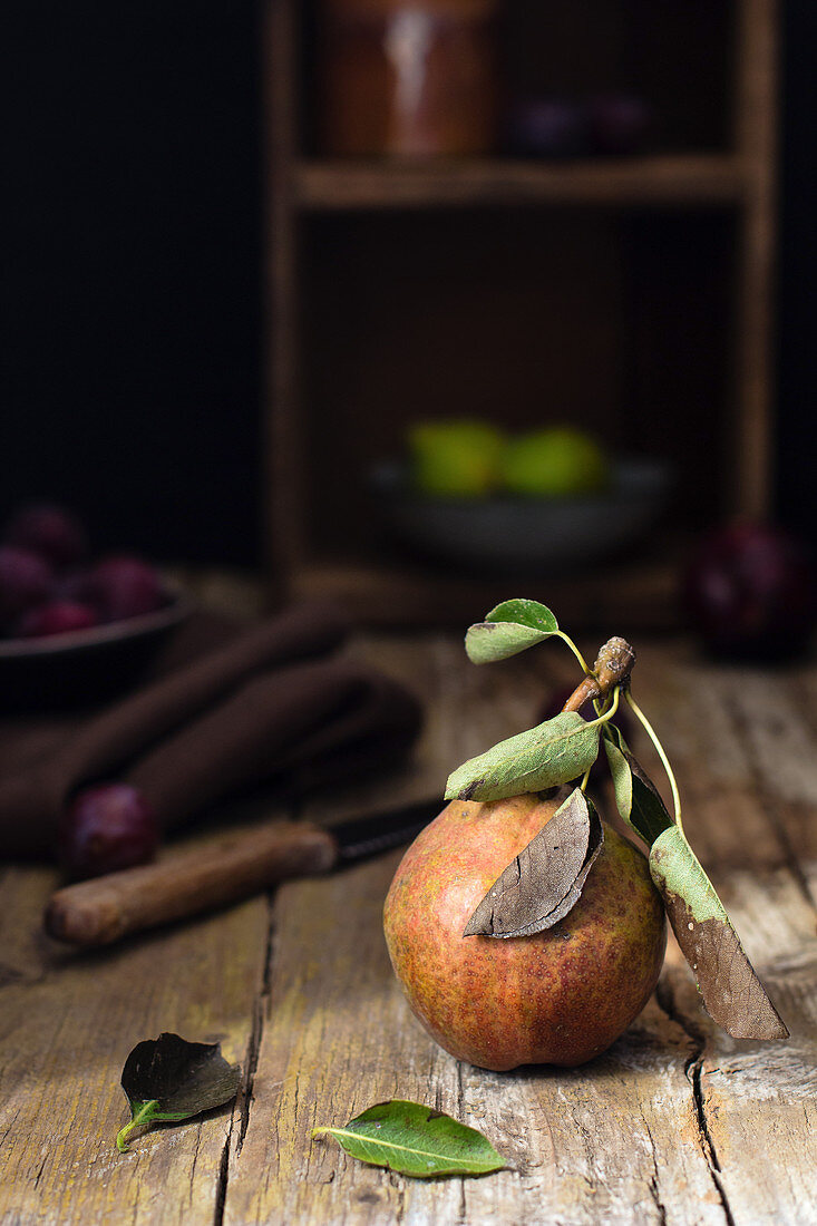 An autumn pear on a rustic wooden background