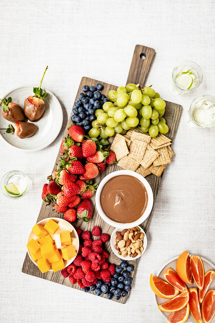 Cheese and fruit board with chocolate sauce