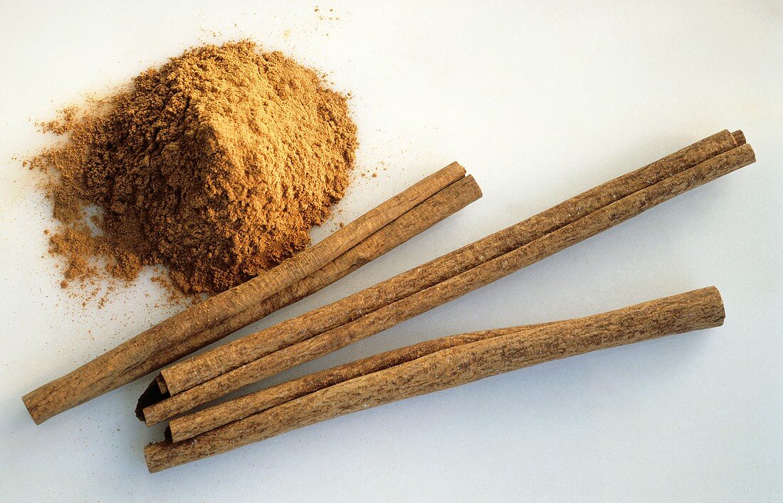 Three Cinnamon Sticks with Grounf Cinnamon