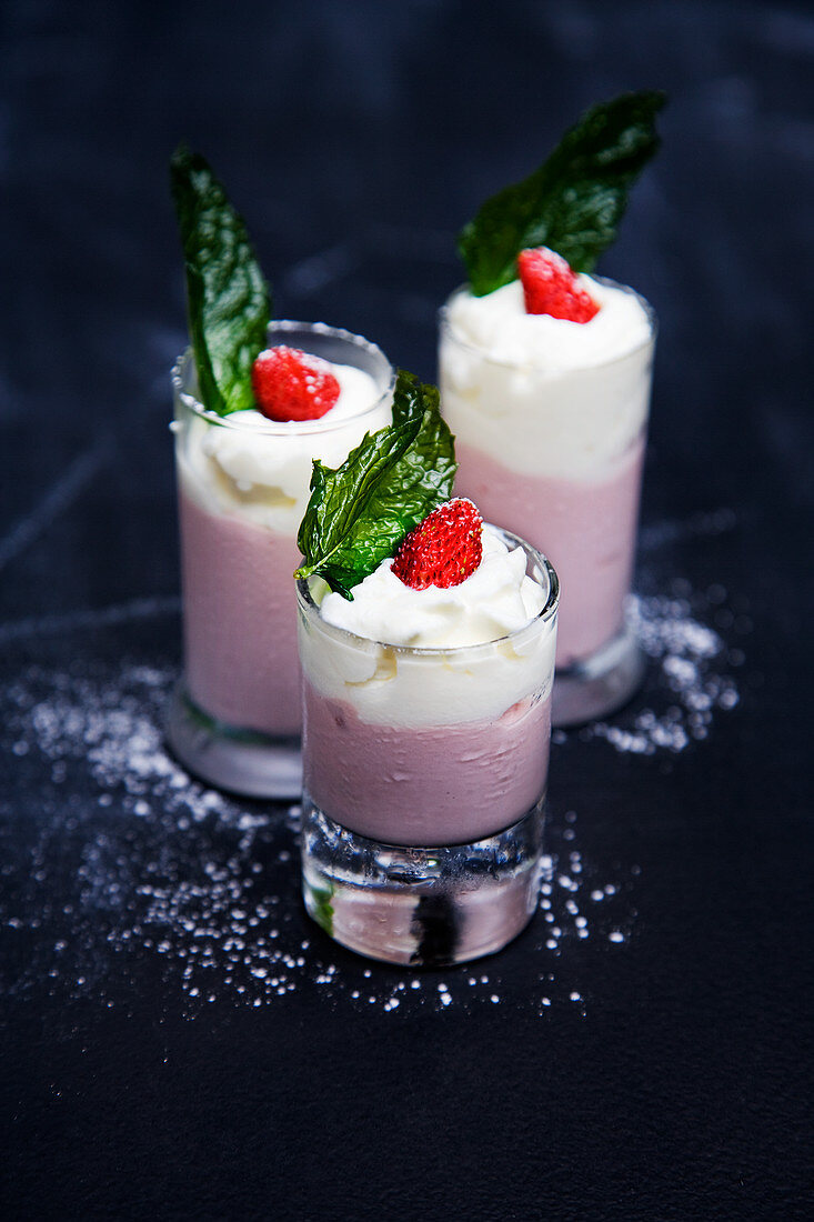 Strawberry shakes with cream served in glasses