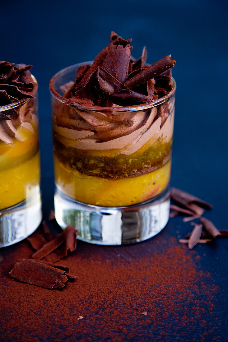 Layered dessert in glasses with orange and chocolate mousse