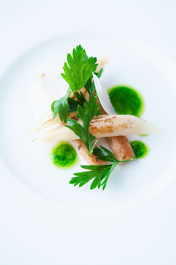 Roasted black salsify with parsley oil and Parmesan