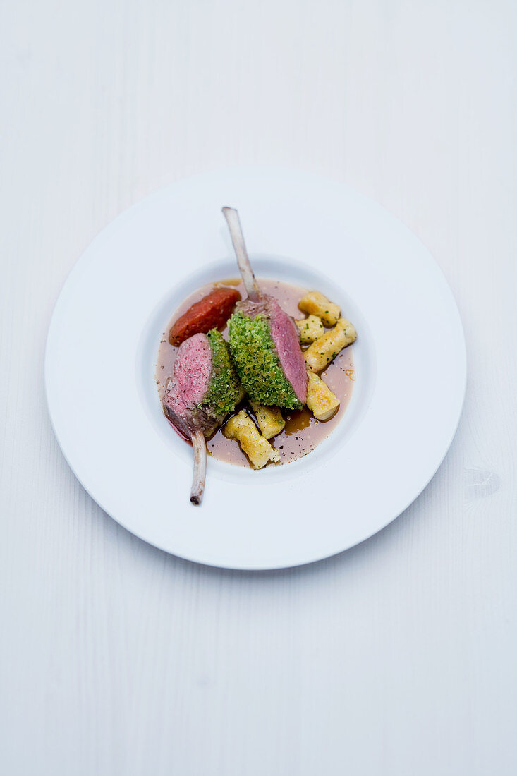 Saddle of milk-fed lamb with a salted almond crust, gorgonzola and rosemary pasta and a tamarind and mustard sauce