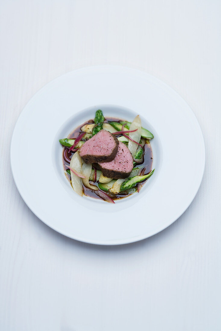 Wagyu beef medallions on poached asparagus