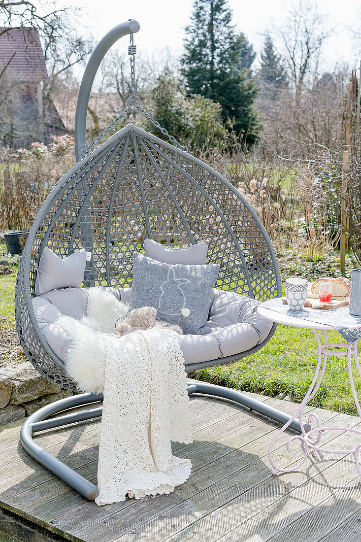 Hanging Chair With Cushions On Wood Terrace