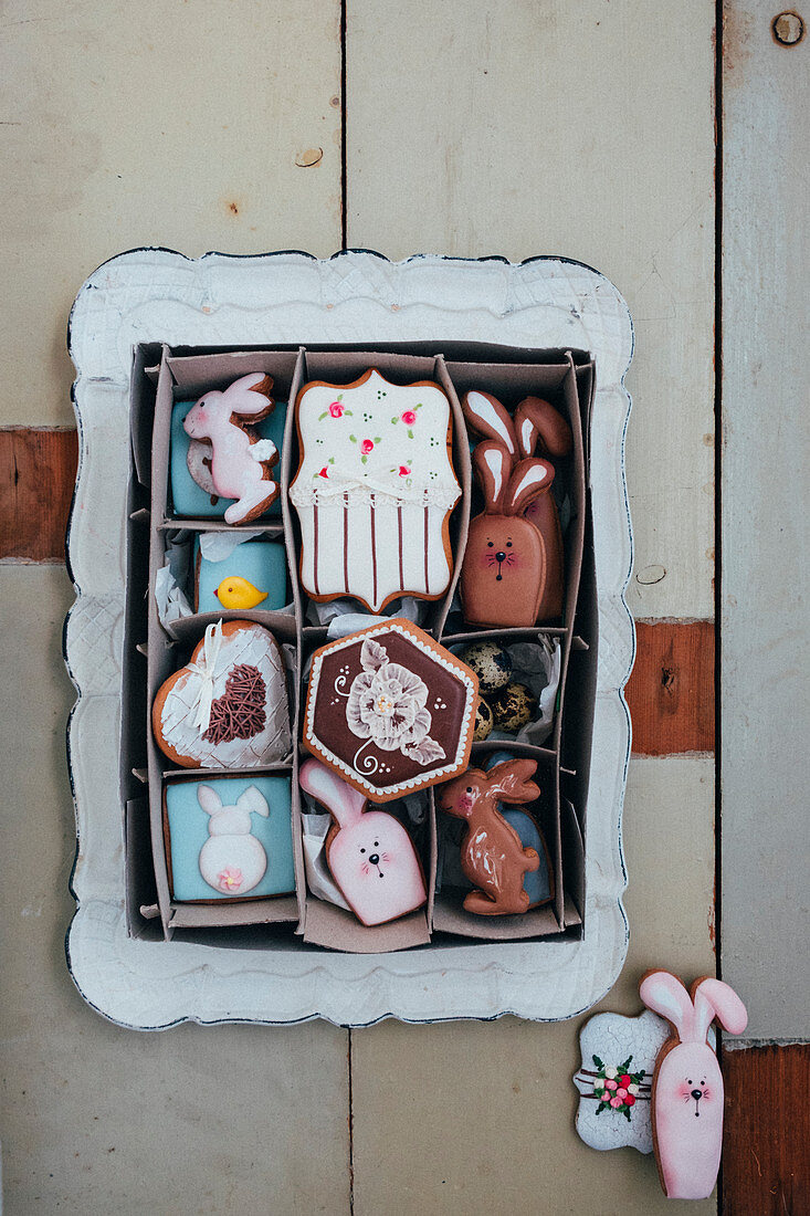 An Easter cookie box filled with royal icing cookies like Easter rabbits