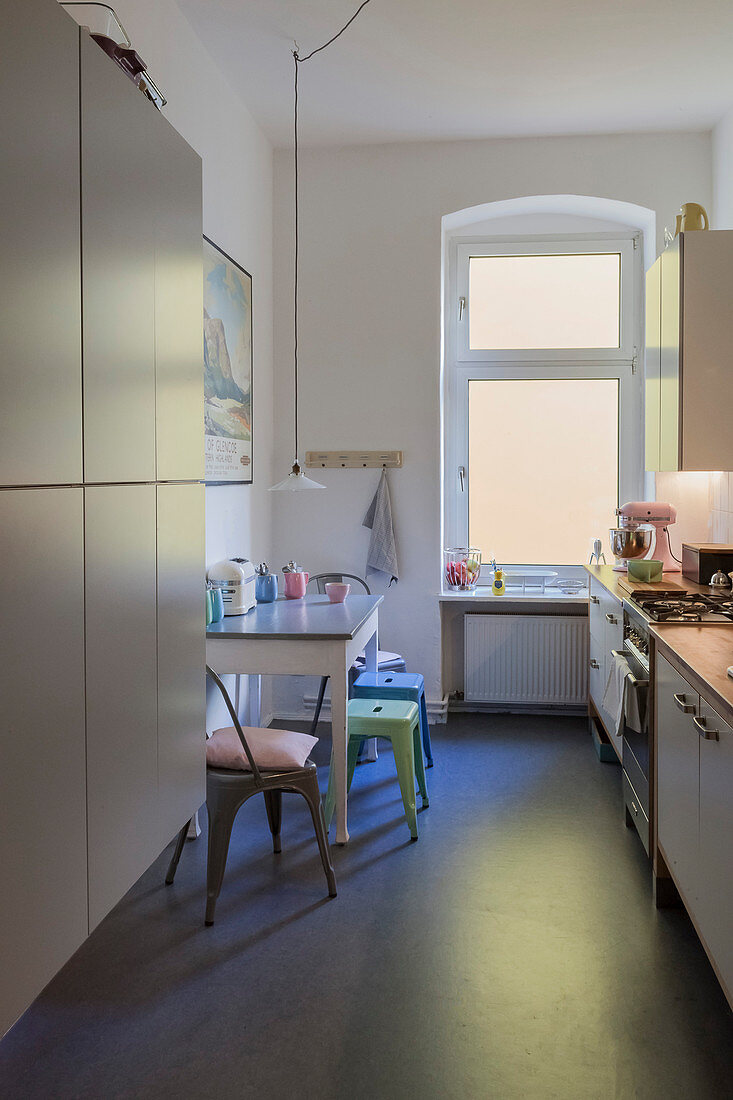 Dining area in narrow kitchen of period apartment