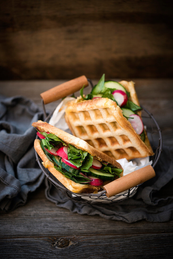 Vegan waffle sandwiches with grilled almond cheese, chard, cucumbers and radishes