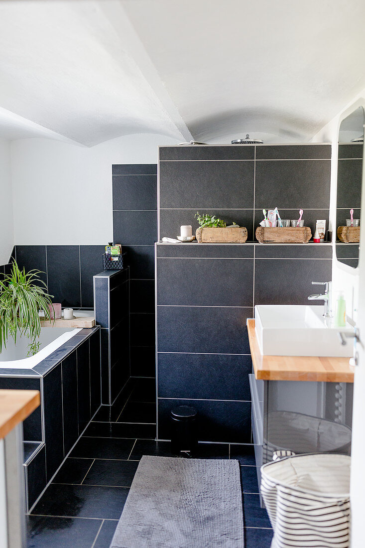 Bathroom with dark tiling