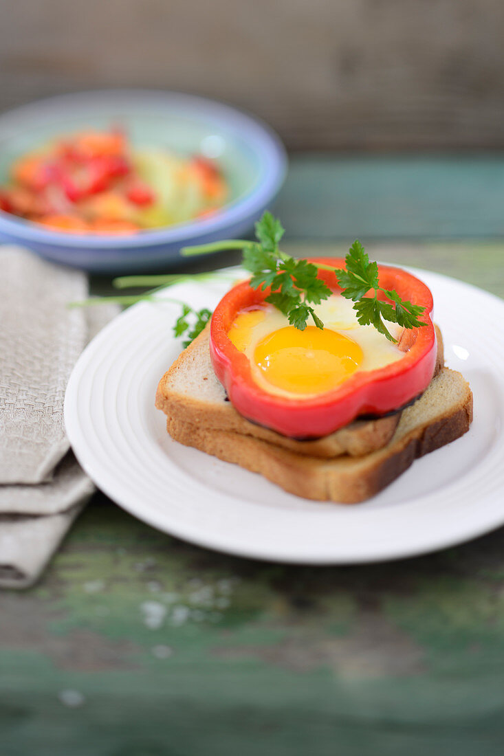 Pepper fried eggs on toast with carrot and cucumber salad