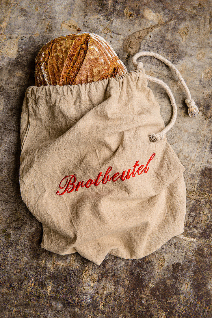 Wholemeal organic bread in a linen bread bag