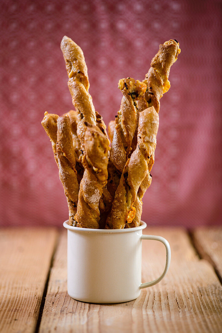 Wild garlic sticks in an enamel mug