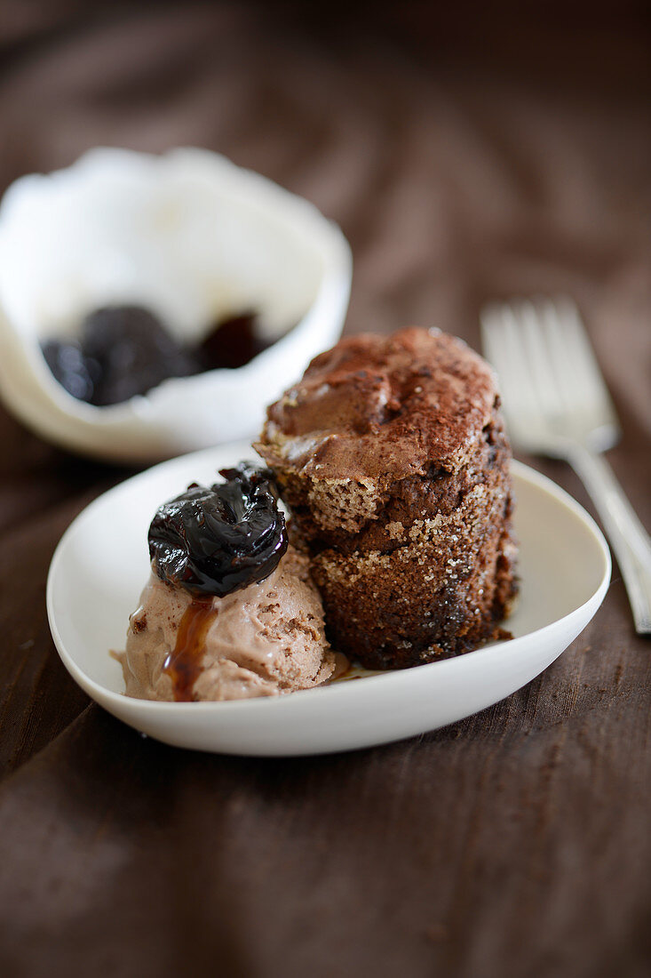 Chocolate souffle with hazelnut ice cream and prunes
