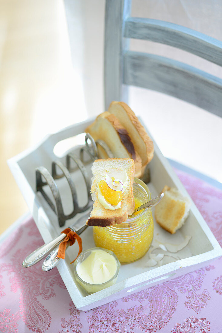 Pineapple and mango jam with grated coconut on toast