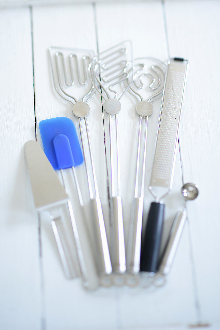 Mixing spoons, a spatula, a melon baller, a grater, and a cake slice