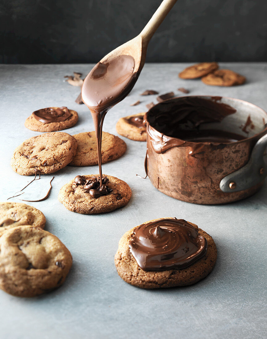 Cookies being drizzled with chocolate