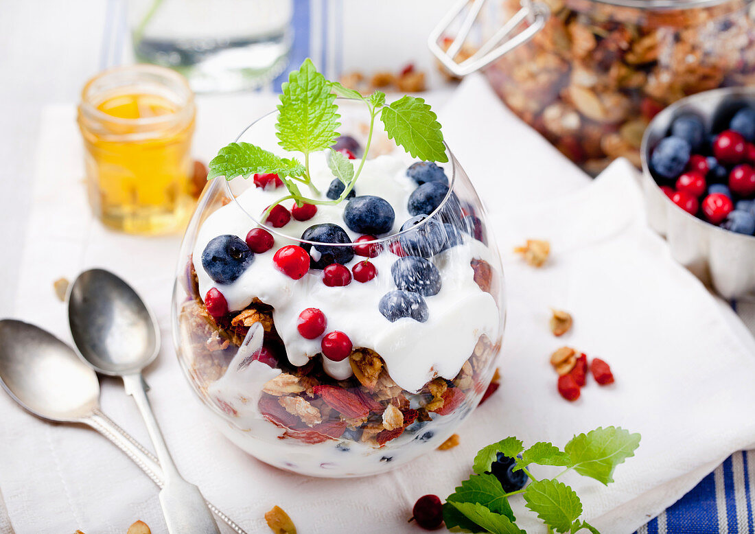 Healthy breakfast. Granola with berries, honey, yogurt and fresh berries