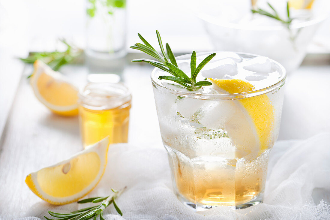 Gin, lemon, rosemary fizz, cocktail with honey and fresh herbs