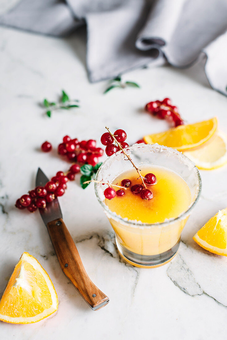 Frischer Orangensaft mit roten Johannisbeeren