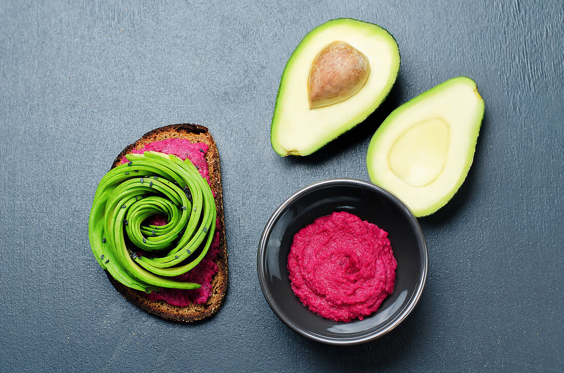 Rye breakfast sandwich with beet hummus and avocado